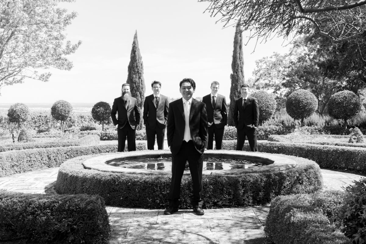 Groom and groomsmen with fountain