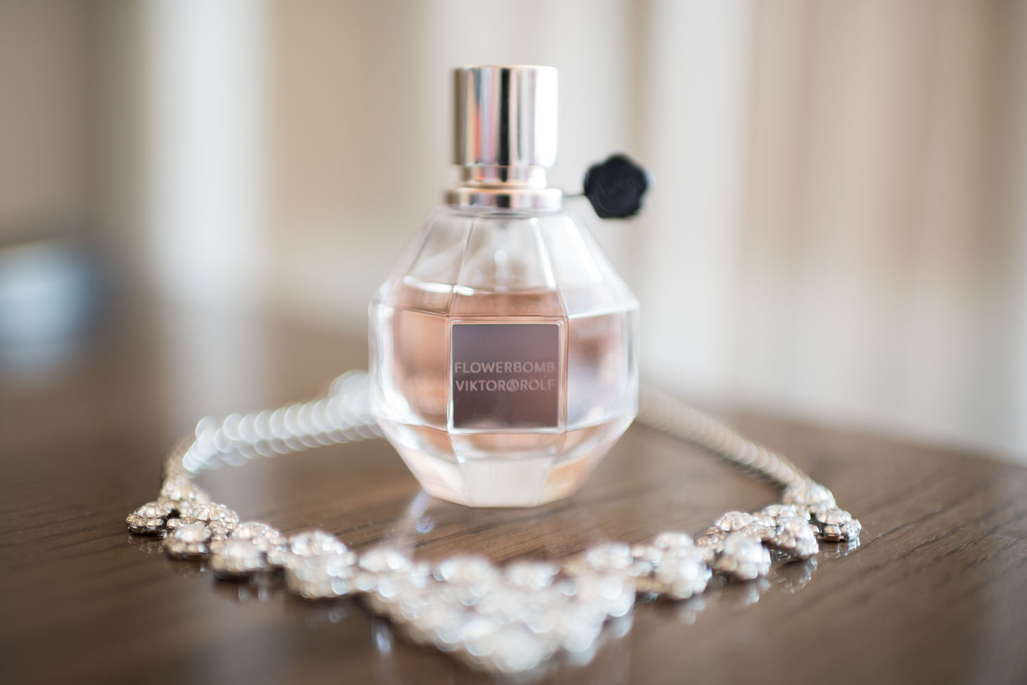 Close up of bride's necklace and perfume