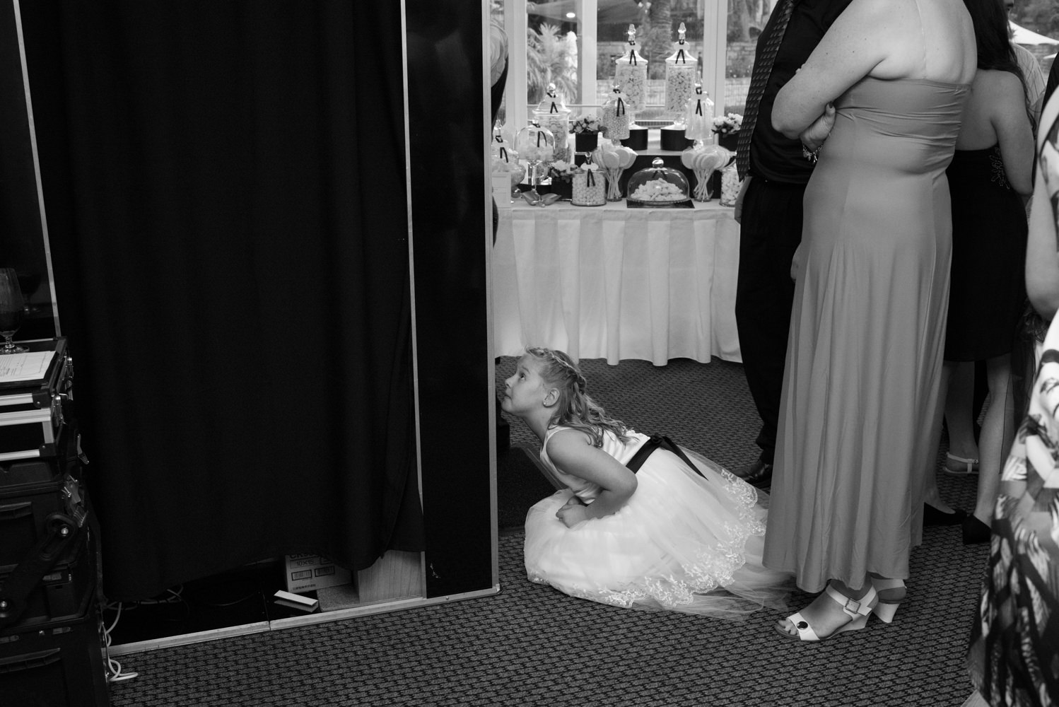 Flower girl peeking in the photo booth