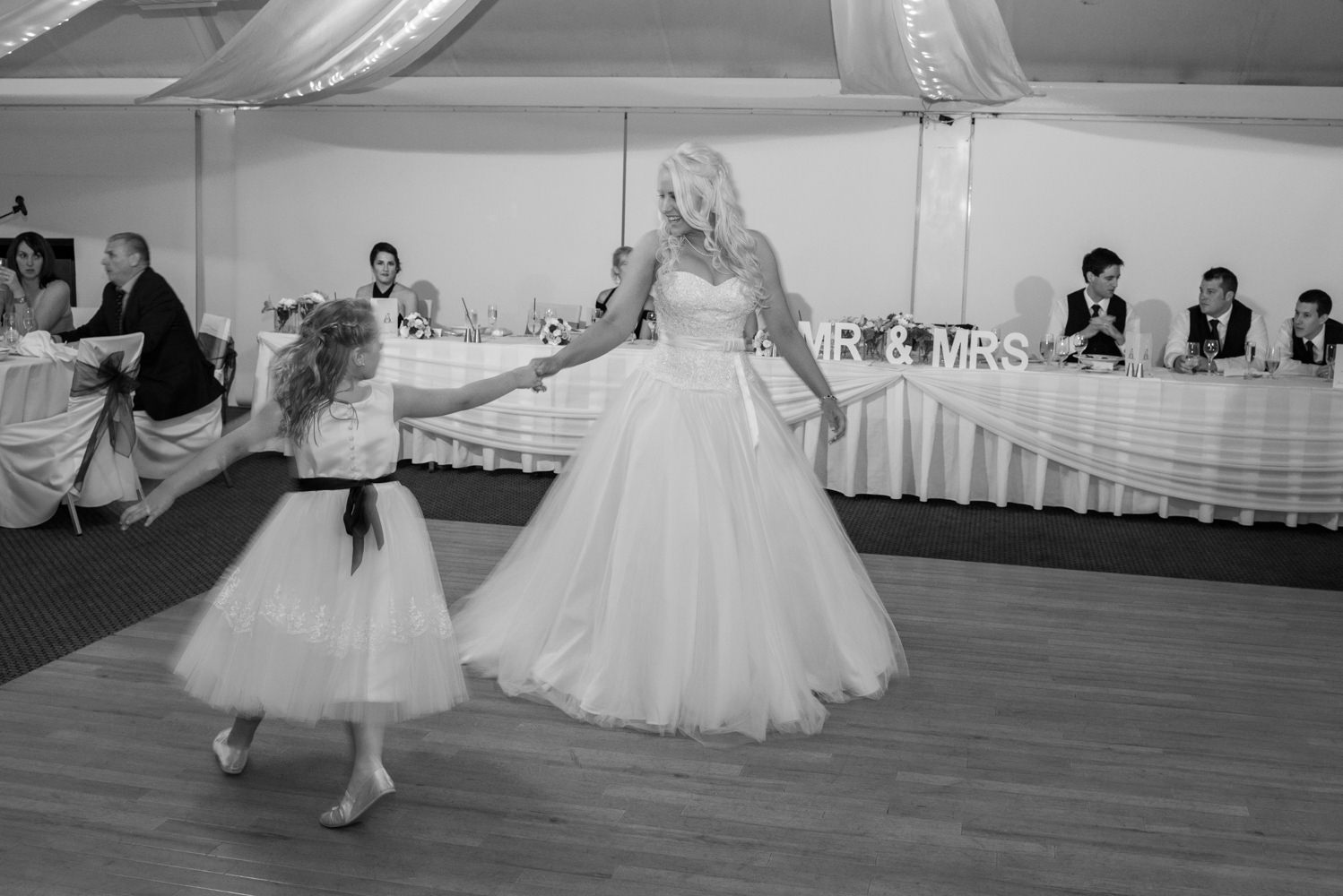 Bride dancing with flowergirl