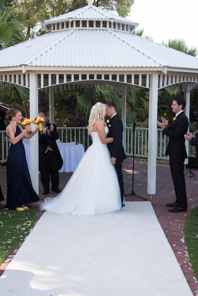 Bride and groom kiss during ceremony