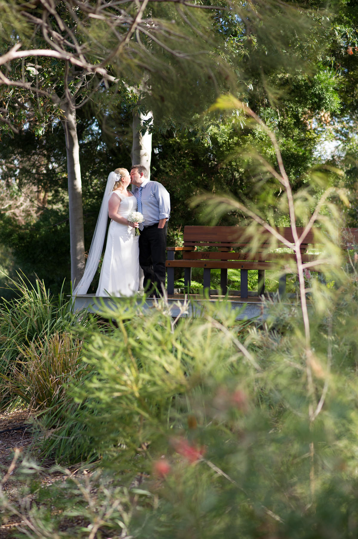 Bride and groom kissing in King's Park, Perth