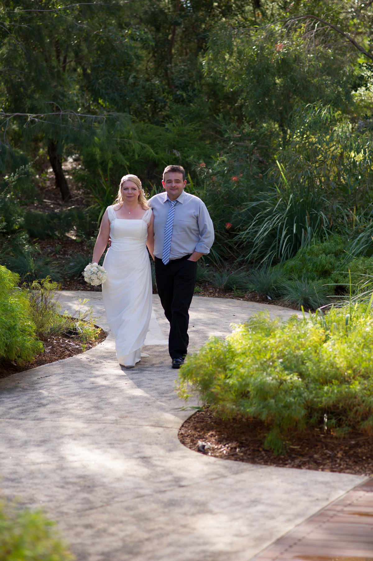 Bride and groom walking along path at King's Park, Perth