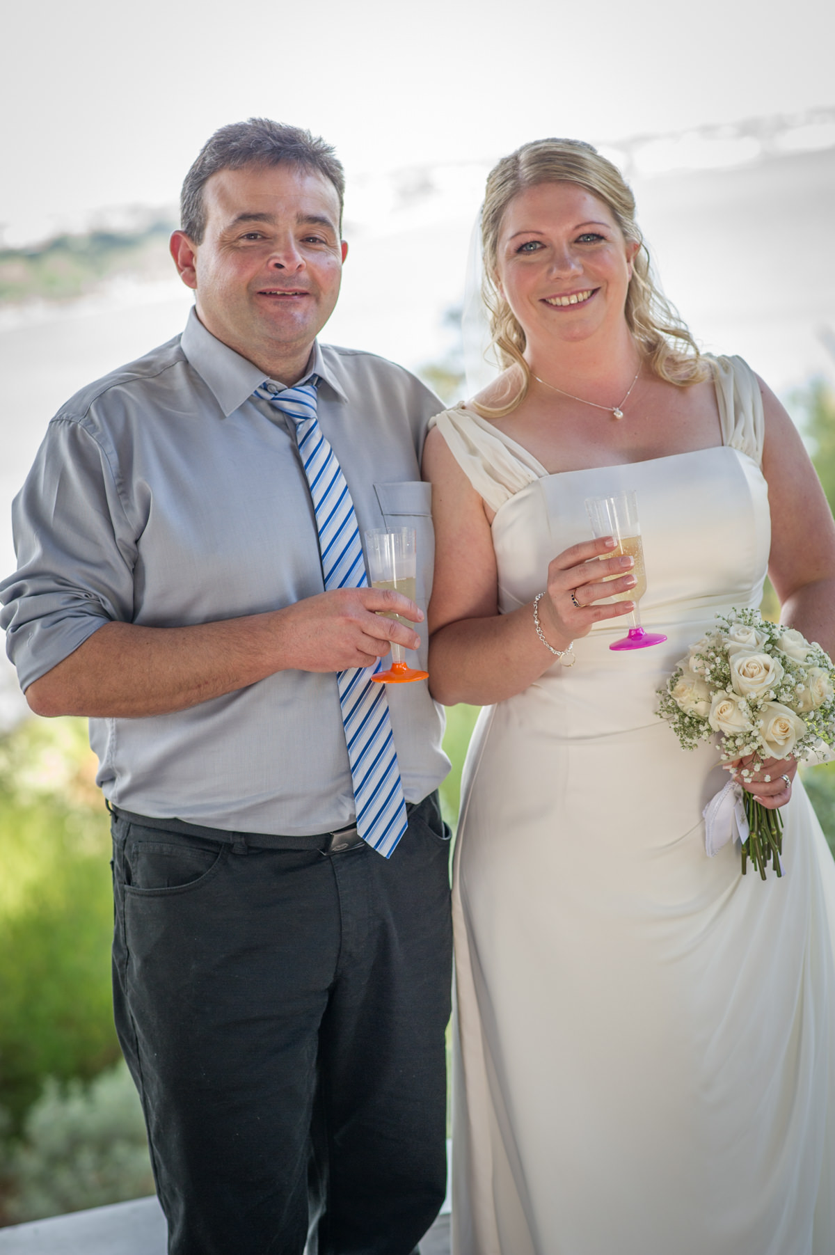 Bride and groom holding champagne glasses in Marlee Pavilion, Perth