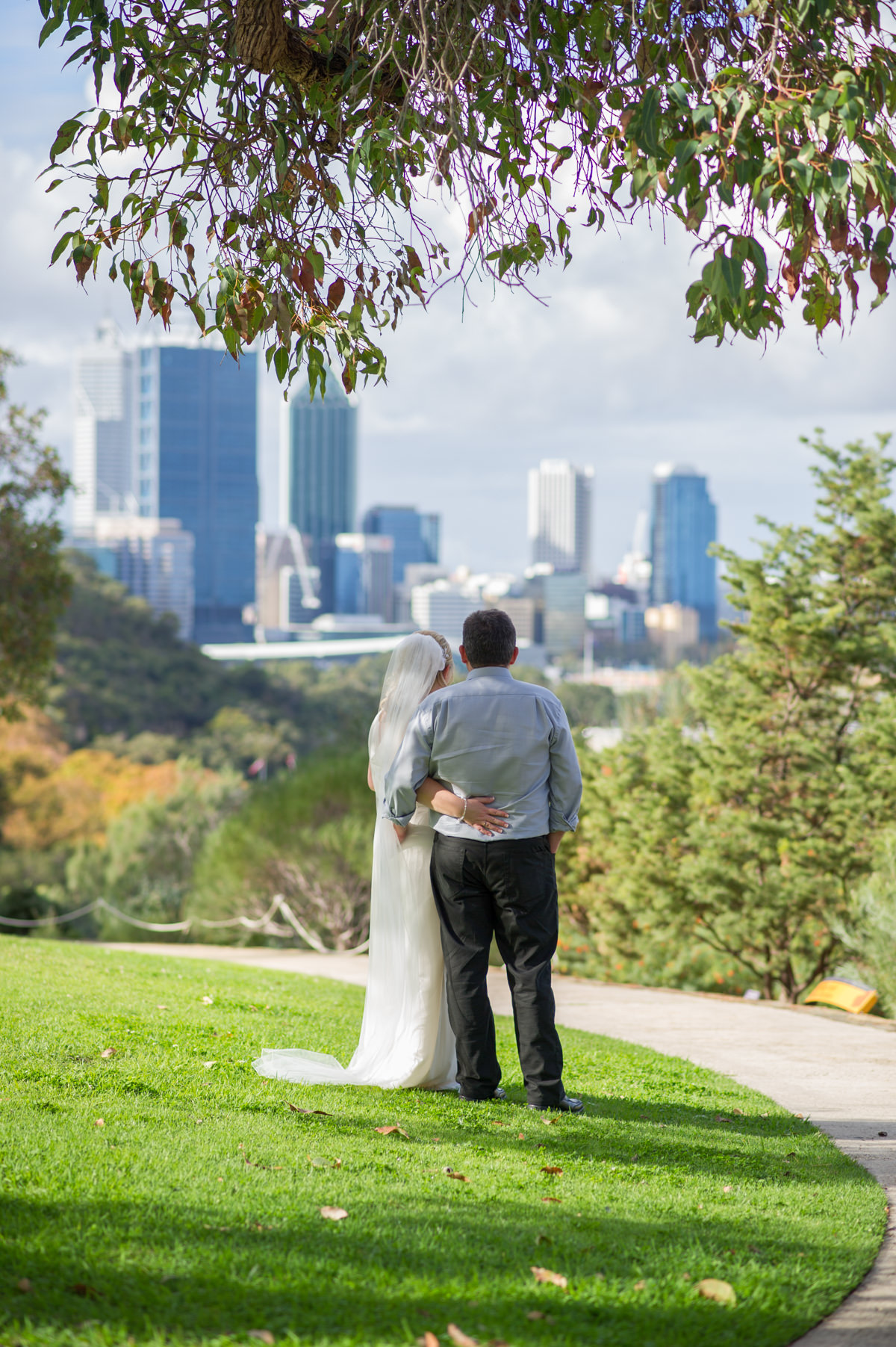 Bride and groom looking at Perth city buildings