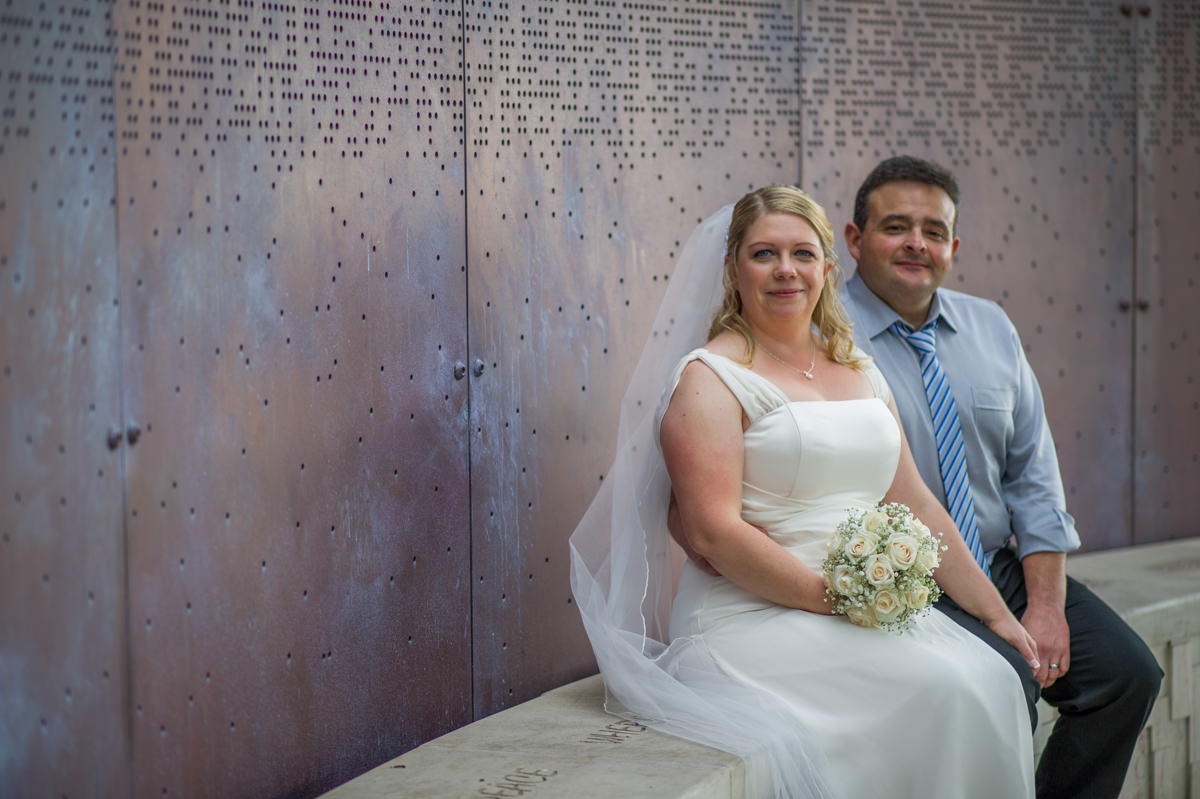Colour photo of bride and groom sitting at Marlee pavilion
