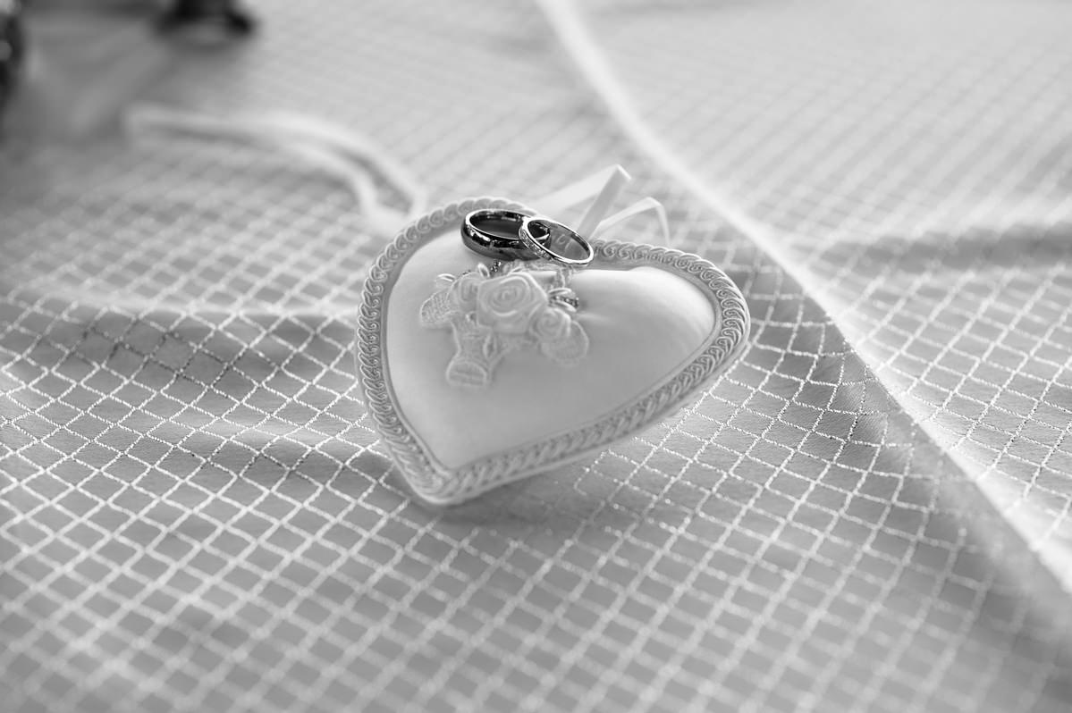 Black and white rings on a ring cushion
