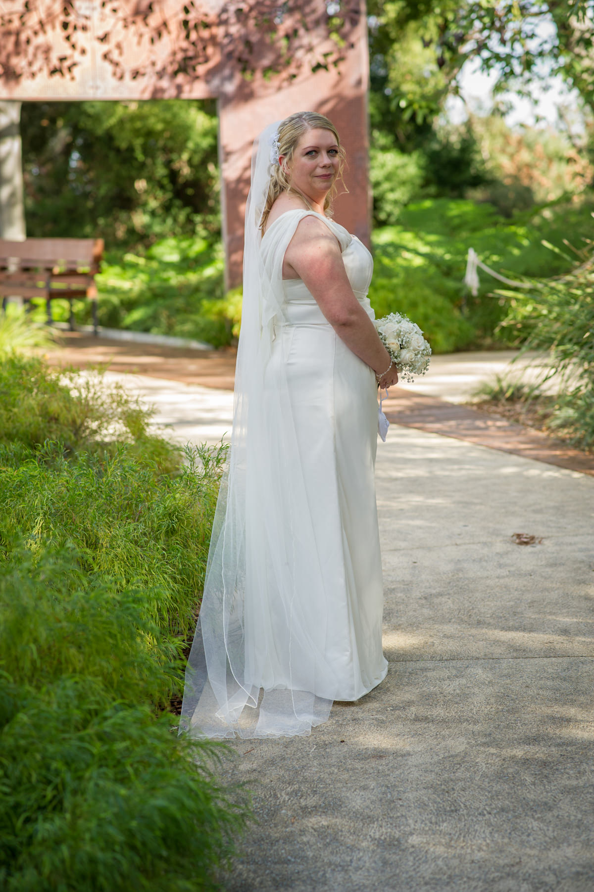 Full length of bride looking over her shoulder