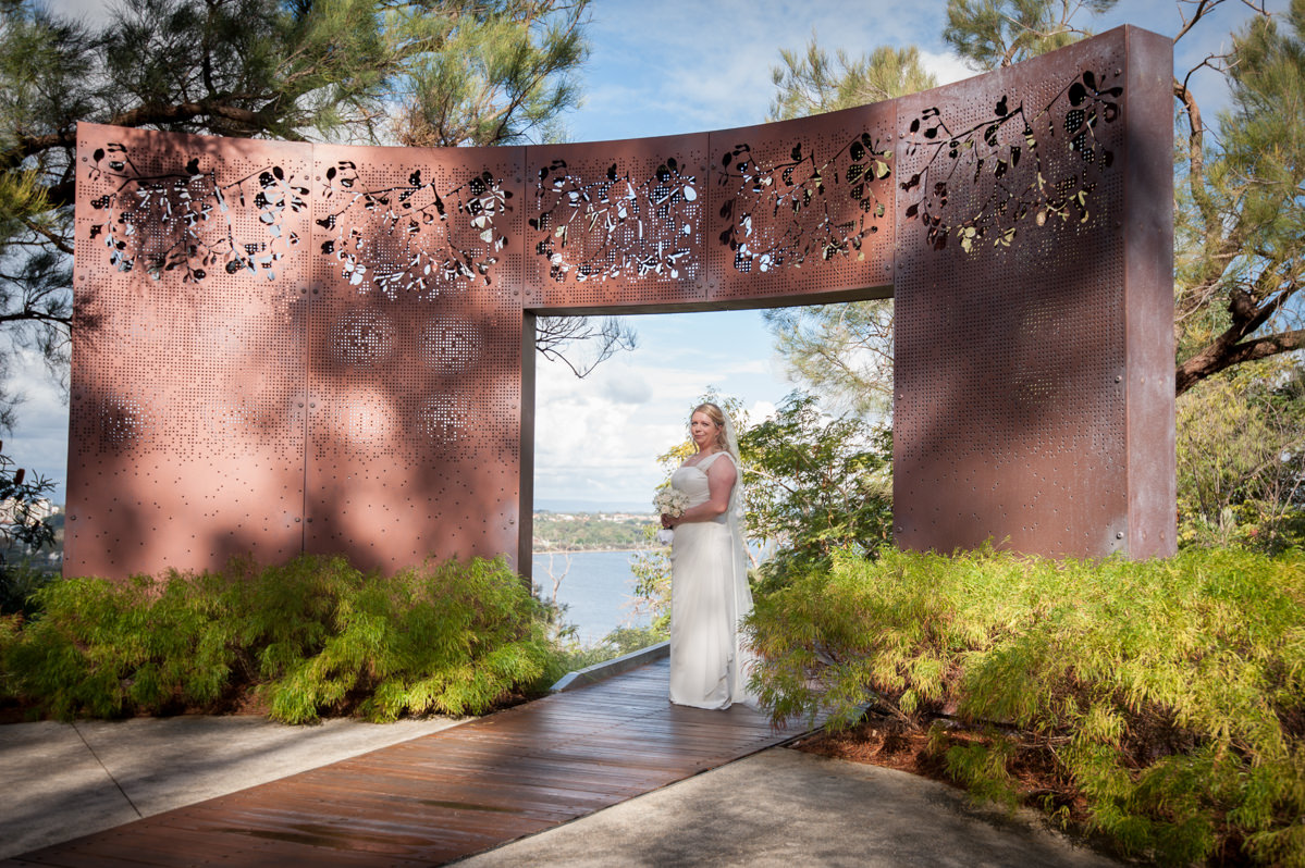 Bride standing under metal arch in King's Park, Perth
