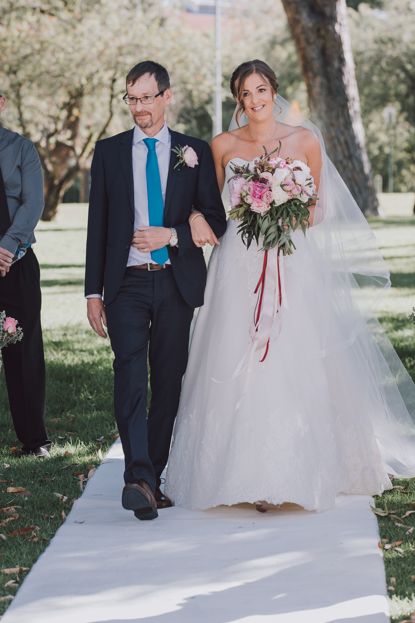 bride and her dad walk down the aisle