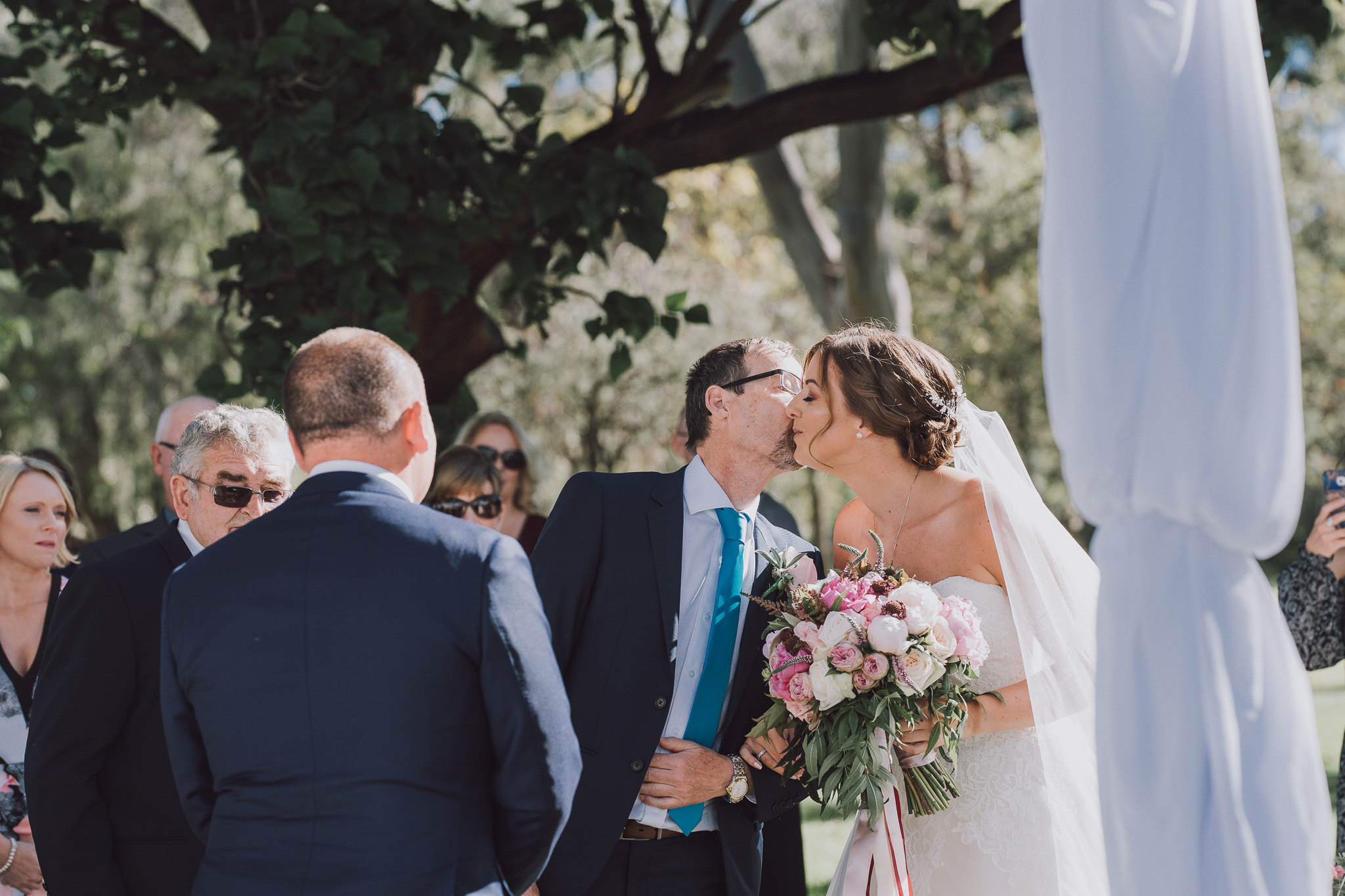bride's dad kisses the bride