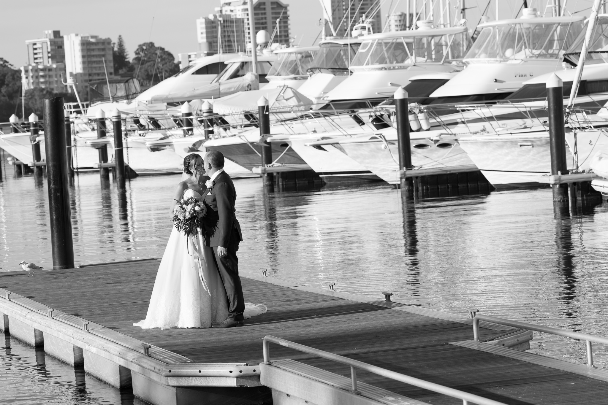 black and white photo of bride and groom on Matilda Bay jetty