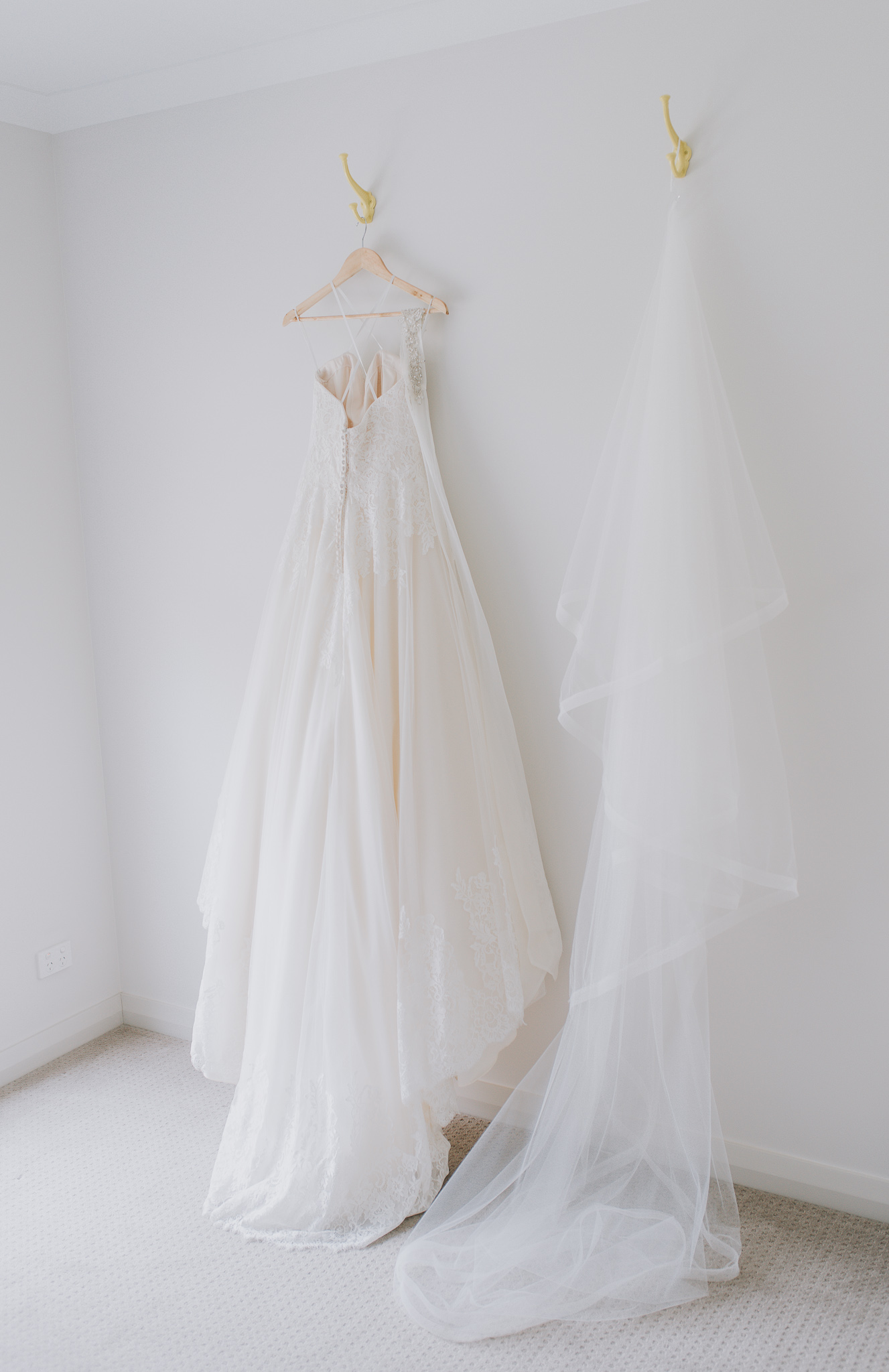 bride's wedding dress and veil hanging