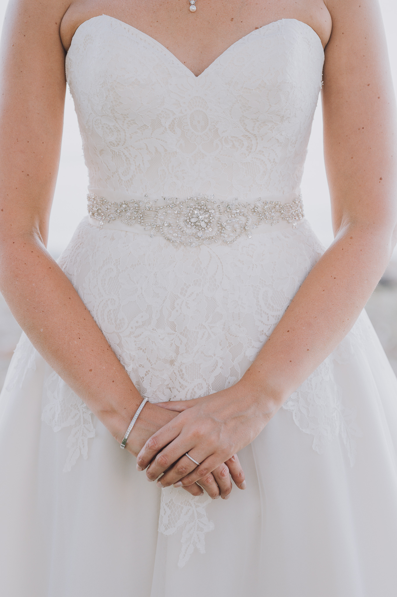 bride holding her hands in front of her wedding dress