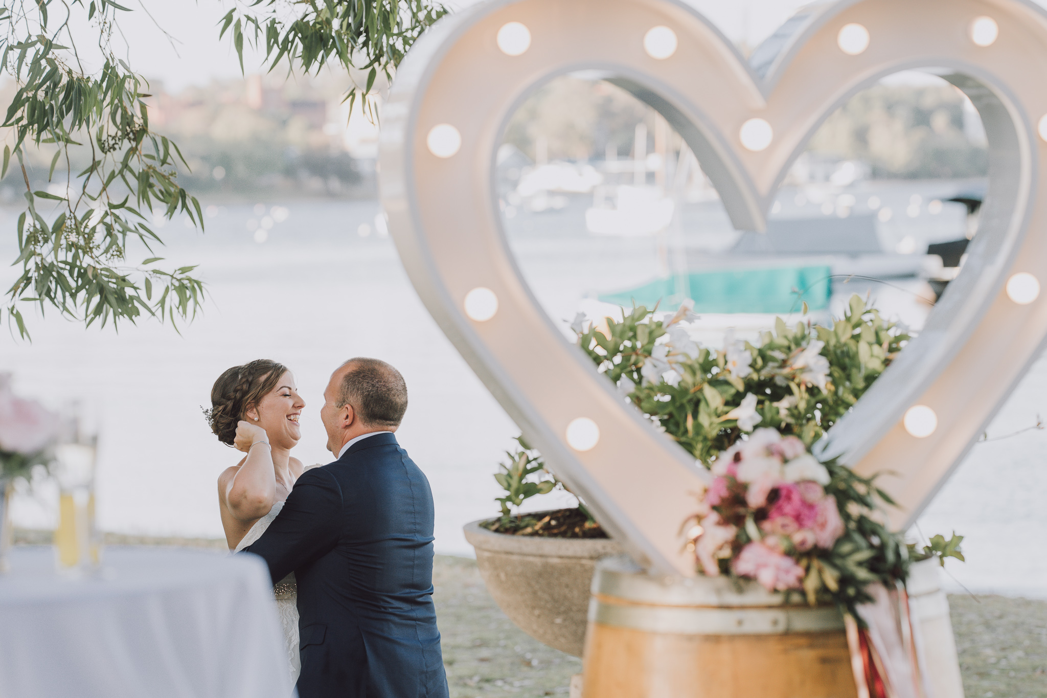 wedding couple behind light up love heart