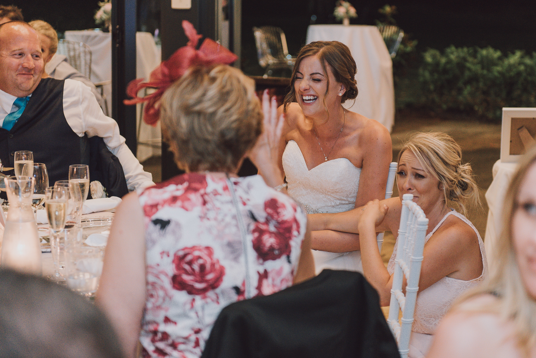 bride laughing during speeches
