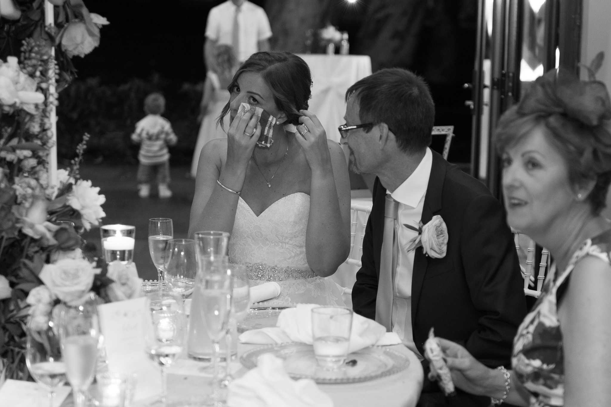 bride dabbing tear from her eyes during speeches