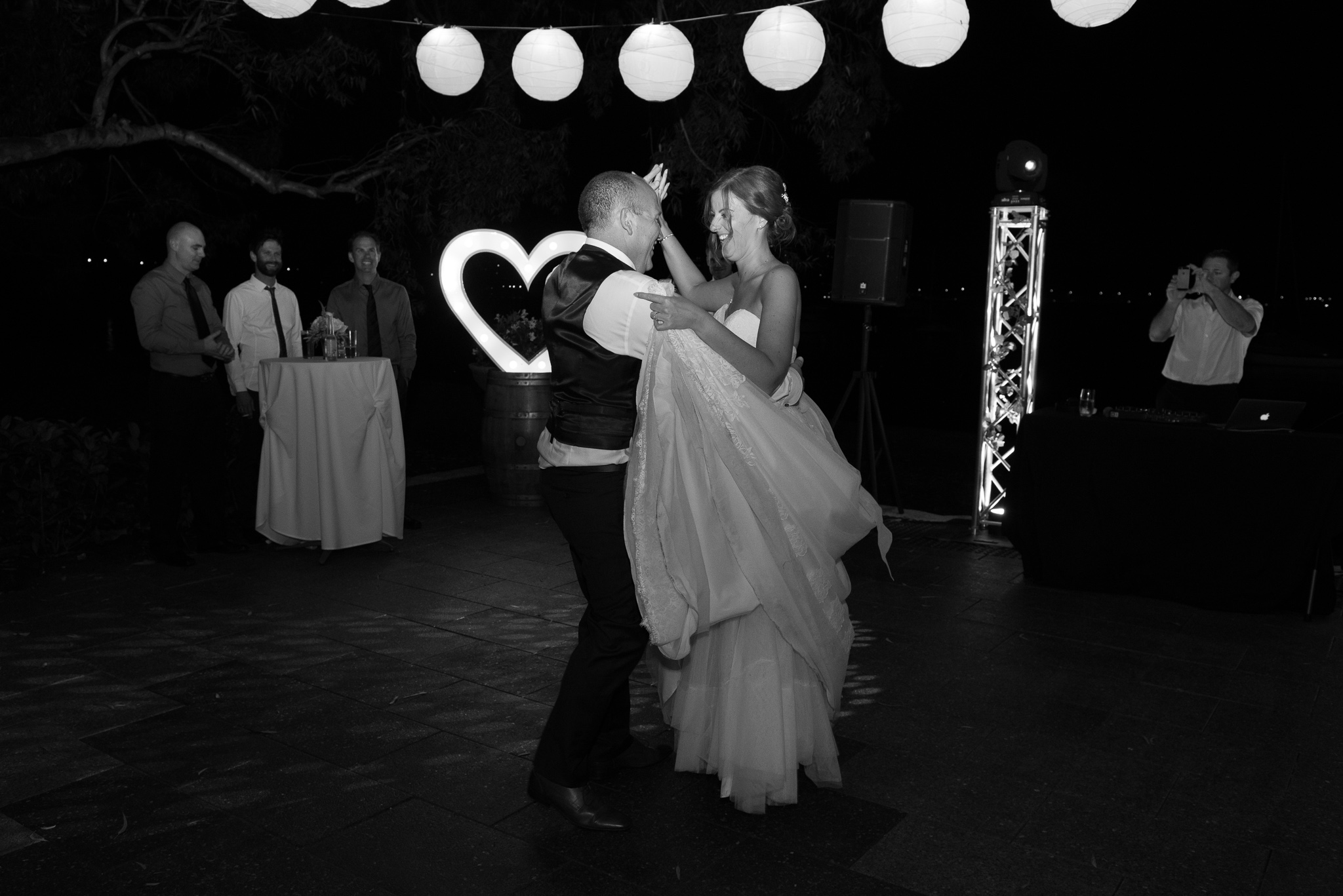 bride and groom dancing at night