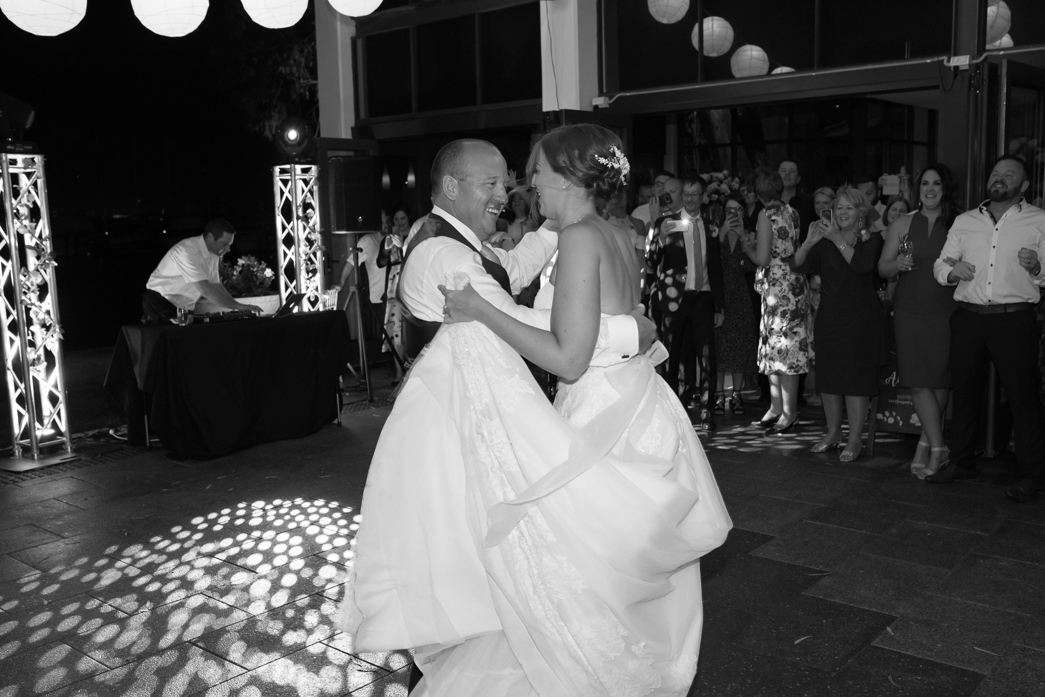 bride and groom dancing in black and white