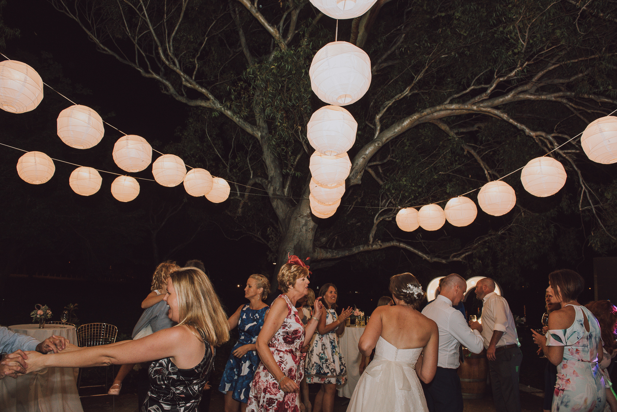 white lanterns over dance floor at night