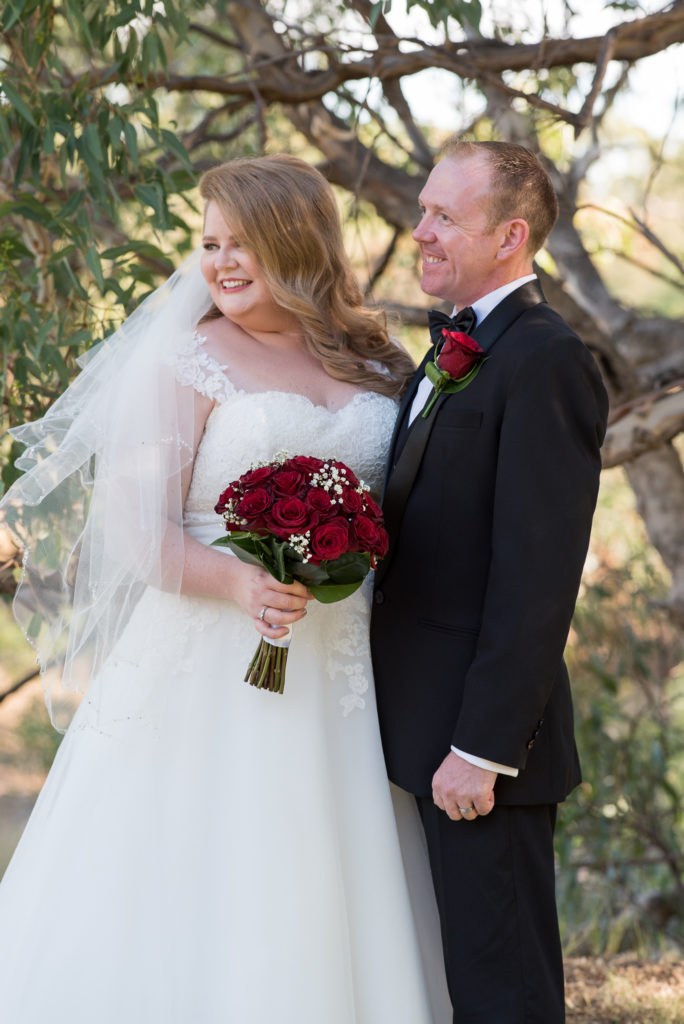 bride and groom waiting during ceremony smiling