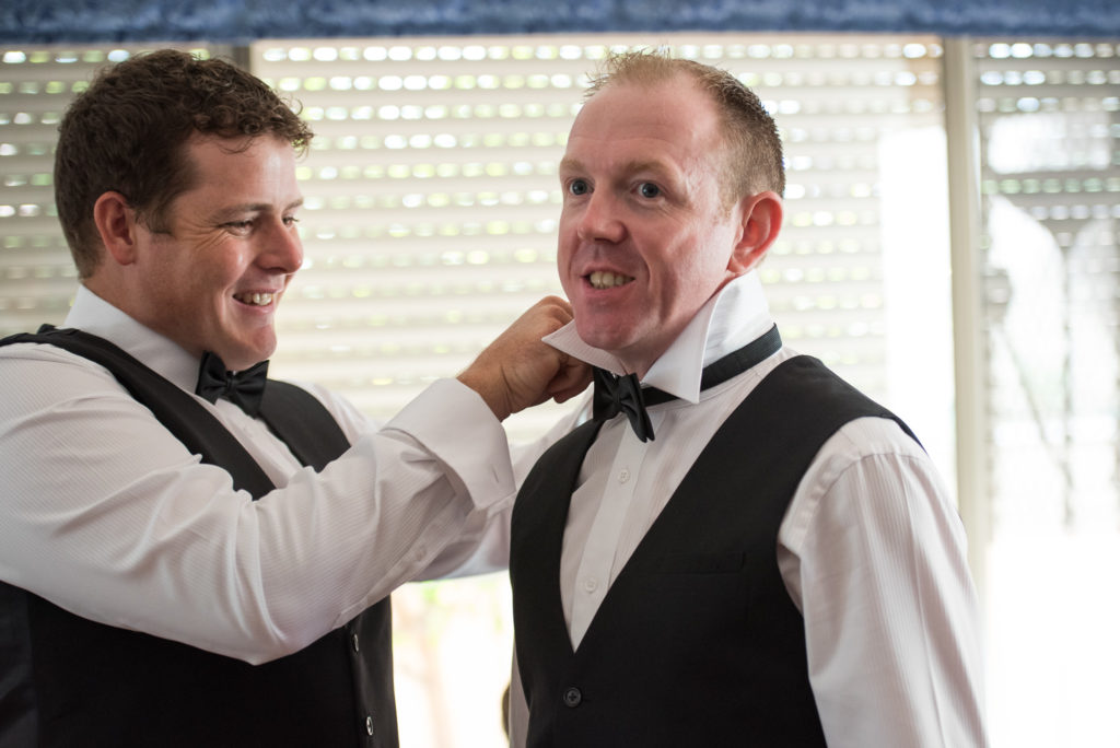 bestman fixing groom's tie
